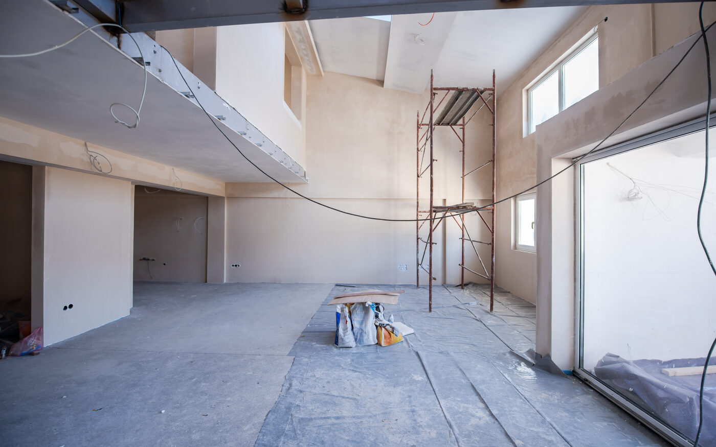 Before: a bare commercial shell under construction with scaffolding and unfinished walls